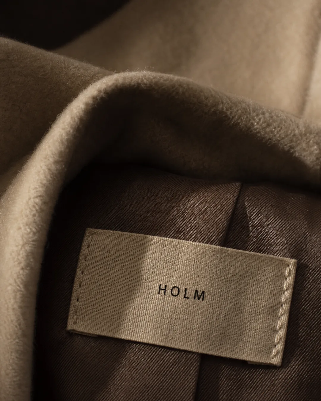 HOLM woven brand label macro detail